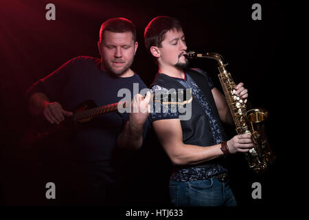 Two musicians on a black background Stock Photo