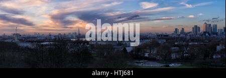 Sunset view over London from Greenwich Park, with The Shard, Canary Wharf and the Thames visible beneath colourful evening clouds. Stock Photo