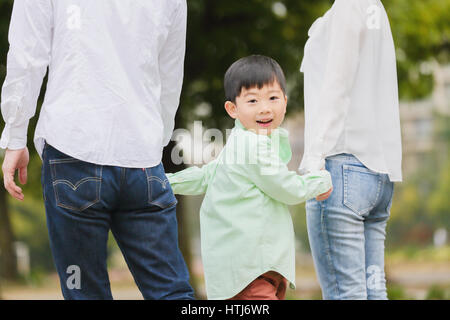Japanese family in a city park Stock Photo