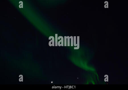 majestic aurora borealis on dark star filled night sky background Stock Photo