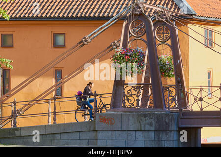 Woman with child cycling over the iron bridge, Uppsala, Sweden, Scandinavia Stock Photo