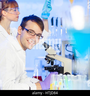 Portrait of a young male researcher microscoping Stock Photo