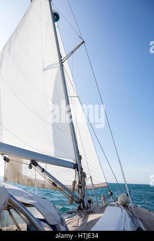 Yacht Sailing On Sea Against Blue Sky Stock Photo