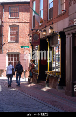 A couple strolls along  Marshall Street in downtown Boston, passing the Green Dragon Tavern Stock Photo