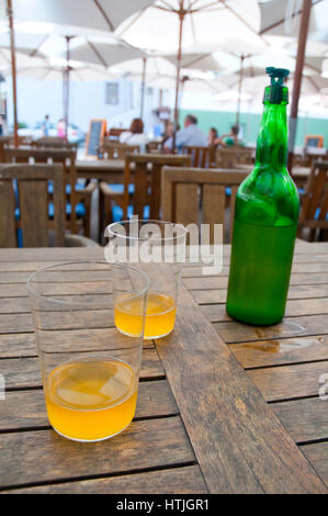 Two glasses and a bottle of cider. Cudillero, Asturias, Spain.