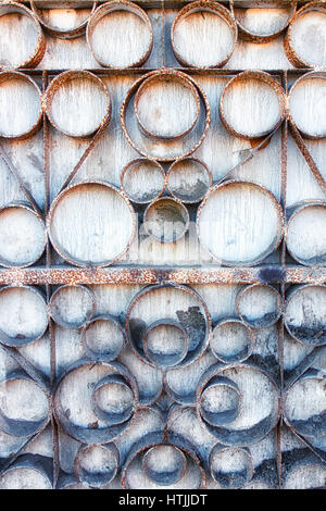An old rusty metal fence. Facade of an old building. Stock Photo