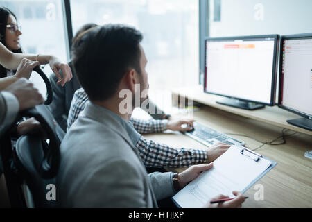 Software engineers developing applications together in office Stock Photo