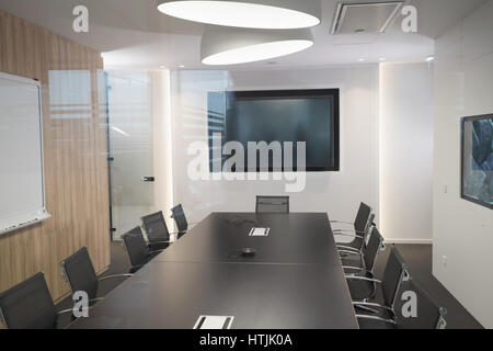 Modern business meeting room with armchairs and desk Stock Photo
