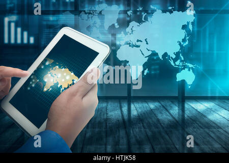 Businessman working on futuristic tablet computer with virtual world map on background Stock Photo