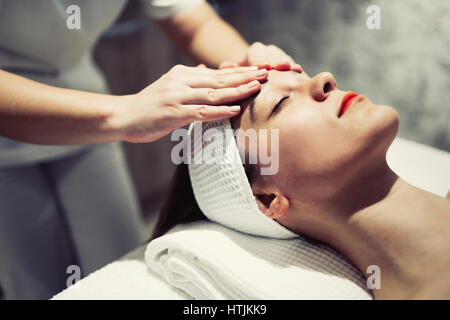 Woman enjoying skin and face treatment and massage Stock Photo