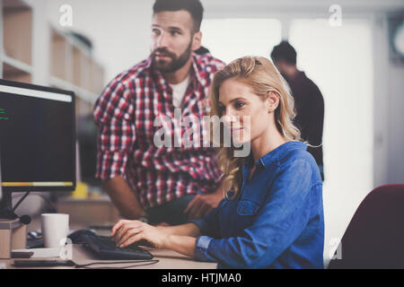 Programmers cooperating at  IT company developing apps Stock Photo