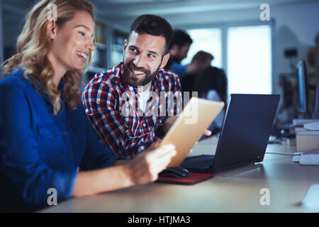Programmers cooperating at  IT company developing apps Stock Photo