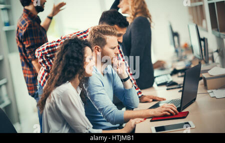 Programmers cooperating at  IT company developing apps Stock Photo