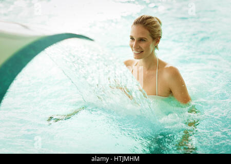 Beautiful woman enjoying jet of water in spa  resort Stock Photo