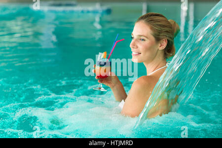 Beautiful woman enjoying jet of water in spa  resort Stock Photo