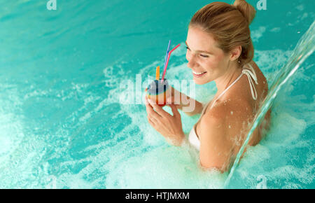 Beautiful woman enjoying jet of water in spa  resort Stock Photo