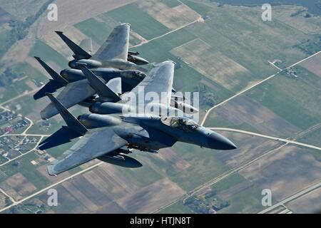 Two U.S. Air Force F-15C Eagle fighter aircraft in flight during a training mission with the Lithuanian Air Force April 23, 2014 over Lithuania.        (photo by Dana J. Butler /U.S. Air Force  via Planetpix) Stock Photo