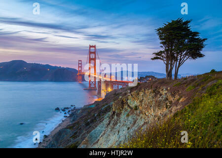 Classic panorama view of famous Golden Gate Bridge seen from scenic Baker Beach in beautiful post sunset twilight at dusk, San Francisco, California Stock Photo