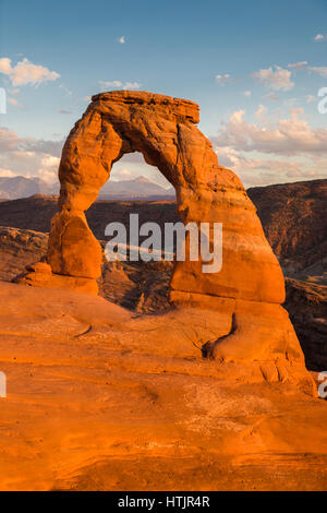 Classic postcard view of famous Delicate Arch, symbol of Utah and a popular scenic tourist attraction, in beautiful golden evening light at sunset in  Stock Photo