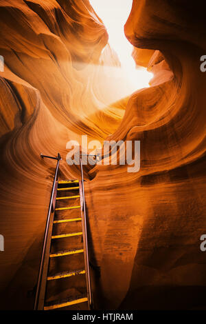 Beautiful view of amazing sandstone formations with a ladder leading toward a magic light beam in famous Antelope Canyon near Page, Arizona, USA Stock Photo