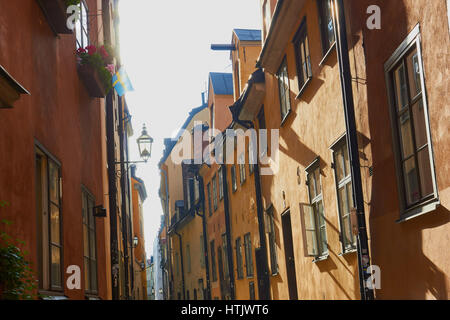 Sunlight on a Swedish flag in a narrow street of Gamla Stan, Stockholm's old town, Sweden, Scandinavia Stock Photo