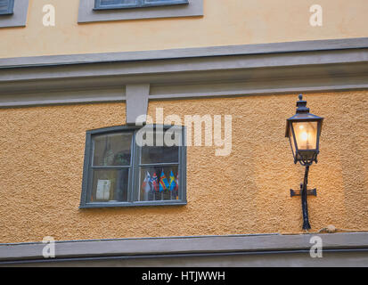 Scandinavian flags in window and old fashioned street lamp, Stockholm, Sweden, Scandinavia Stock Photo