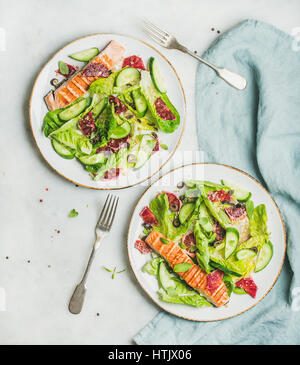 Healthy spring salad with grilled salmon, orange, olives and quinoa