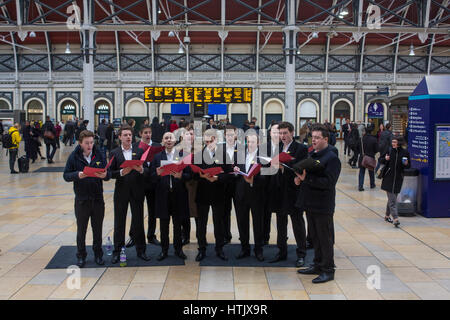 A Welsh male voice choir at Paddington Station on St David's Day Stock Photo