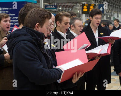 A Welsh male voice choir at Paddington Station on St David's Day Stock Photo