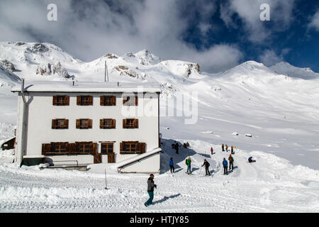 Skiers and hikers outside the Heidelberger Hut in the Austrian Alps. Stock Photo