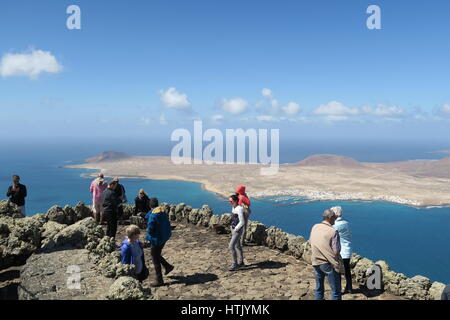 Tourists looking at La Graciosa from the Mirador del Rio on Lanzarote Stock Photo