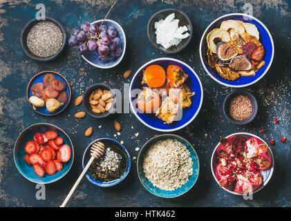 Fresh and dried fruit, chia seeds, oatmeal, nuts, honey Stock Photo