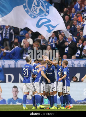 Gelsenkirchen, Germany. 12th Mar, 2017. Schalke's team celebrates the 3:0 goal during the Bundesliga soccer match between FC Schalke 04 and FC Augsburg at the Veltins Arena in Gelsenkirchen, Germany, 12 March 2017. (EMBARGO CONDITIONS - ATTENTION: Due to the accreditation guidlines, the DFL only permits the publication and utilisation of up to 15 pictures per match on the internet and in online media during the match.) Photo: Ina Fassbender/dpa/Alamy Live News Stock Photo