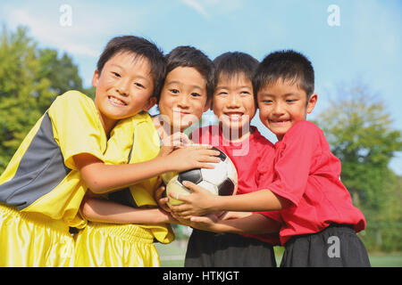 Japanese kids playing soccer Stock Photo