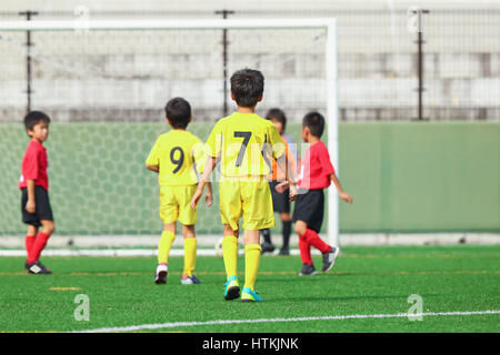 Japanese kids playing soccer Stock Photo