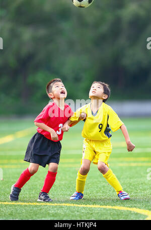 Japanese kids playing soccer Stock Photo