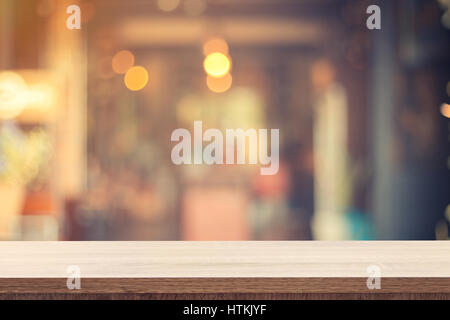 Empty wooden table for product placement or montage and blurred coffee shop backdrop. Stock Photo