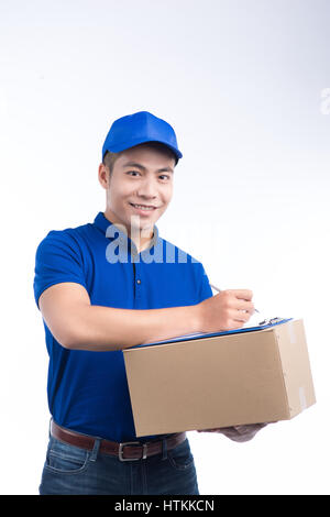 Delivery man writing down notes on clipboard isolated over white background Stock Photo