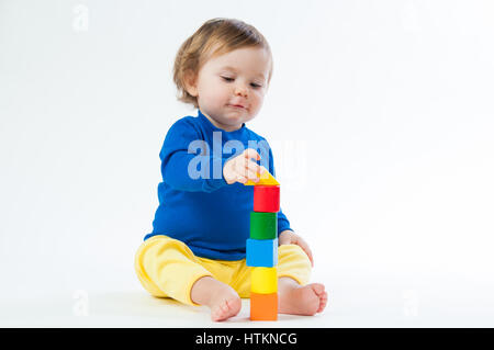 Little child playing with dices isolated on white background Stock Photo