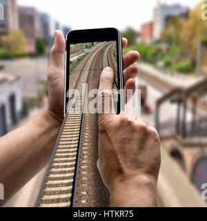 Two hands holding a mobile phone. Concept for Station departures Stock Photo