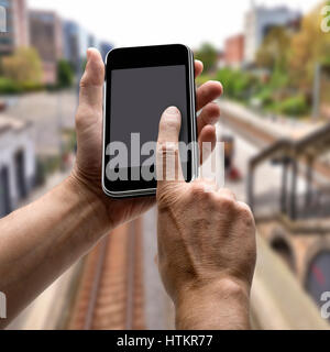 Two hands holding a mobile phone. Concept for Station departures Stock Photo