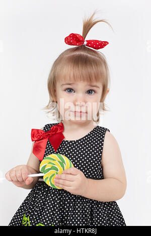 The little girl holds big beautiful lollipop Stock Photo