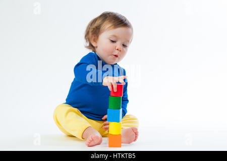 Little child playing with dices isolated on white background Stock Photo