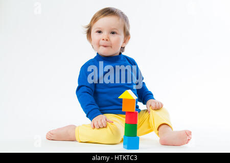 Little child playing with dices isolated on white background Stock Photo