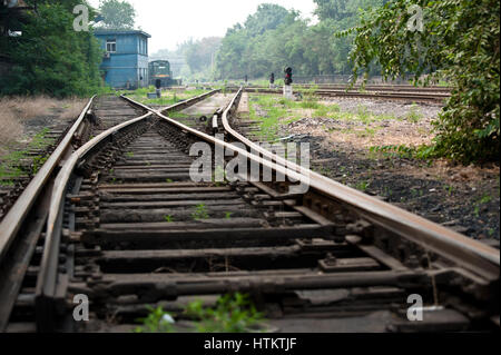 Abandoned railway and a locomotive at a old steel works Stock Photo