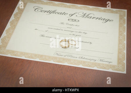 gold wedding rings on a marriage certificate Stock Photo