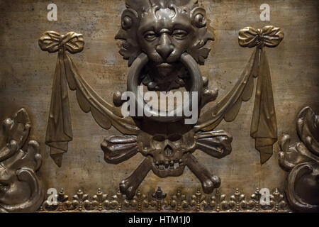 Skull and bones and doorknocker depicted on the sarcophagus of Empress Maria Anna (1606 - 1646) in the Kaisergruft (Imperial Crypt) in Vienna, Austria. Empress Maria Anna was the first wife of Holy Roman Emperor Ferdinand III. She is better known as Infanta Maria Anna of Spain pictured by Spanish painter Diego Velazquez. Stock Photo