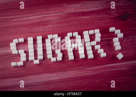 Word SUGAR with question mark made of sugar cubes Stock Photo