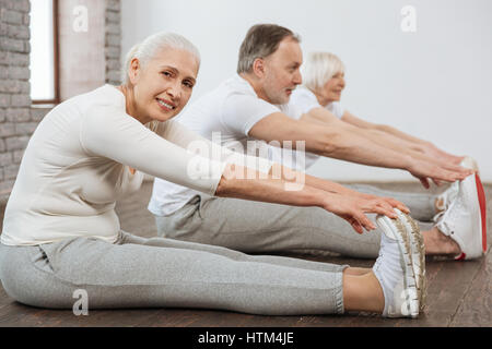 Attractive woman touching her sneakers Stock Photo