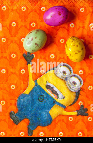 M&S chicky choccy speckled eggs, milk chocolate eggs with a speckled candy shell, on serviette with Minions - Minion juggling with them for Easter Stock Photo